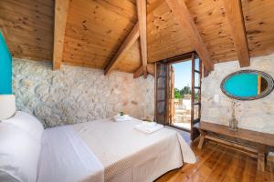 a bedroom with a bed and a large window at Abeloklima superior apartment in Vasilikos