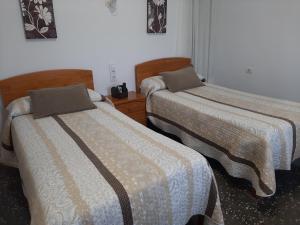 Postel nebo postele na pokoji v ubytování Pensíon Lucia
