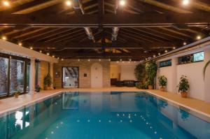 a large swimming pool with a large ceiling and a large pool at LO CLAUSTRE DEL DELTA- LUX FINCA in Delta del Ebro - FINCA PRIVADA -NO HAY NINGUN SERVICIO HOTELERIA- SOLO ALOJAMIENTO in Sant Carles de la Ràpita