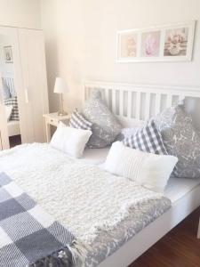 a white bed with pillows on top of it at Ferienwohnungen in der Uckermark in Schönermark