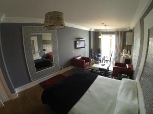 ラゴスにあるInn Seventiesのベッドと鏡が備わるホテルルーム