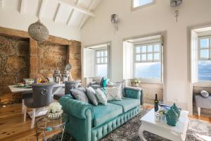 a living room with a blue couch and a table at Oporto Platinum Loft in Porto