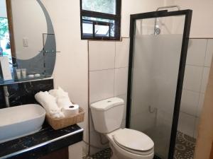 a bathroom with a toilet and a sink and a shower at Purple Orchid Bed and Breakfast in Tagaytay