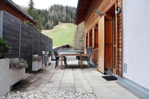 a patio with a table and chairs on a house at Appartement Kaiserhof in Bad Kleinkirchheim