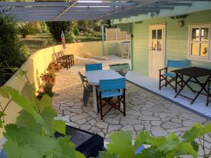 a patio with a table and chairs on a patio at THE CABIN, KYPARISSIA in Kyparissia