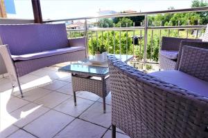 a patio with chairs and a table on a balcony at Katerinas House in Nikiti