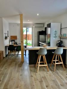 a kitchen with a table and two stools at Cottage La Villa Sant Martí in Perpignan