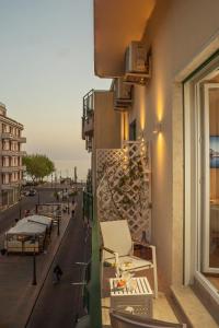 a balcony of a building with chairs and a street at La Serenata Luxury in Maiori