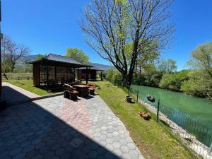 a gazebo next to a body of water at Apartments and Rooms Villa Majestic in Bihać