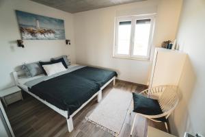 a bedroom with a bed with a green blanket at Apartment ENJOY BLUE, with pool & pets welcome in Novigrad Istria
