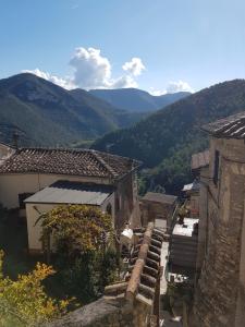 a view of two buildings with mountains in the background at BORGO NEL TEMPO in Collestatte