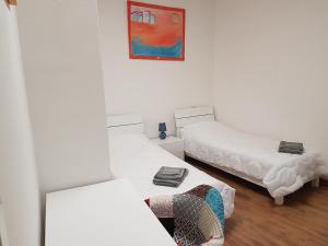 a room with two beds and a painting on the wall at BORGO NEL TEMPO in Collestatte