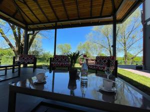 a table with wine glasses and chairs on a patio at Apartments and Rooms Villa Majestic in Bihać