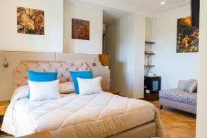 a bedroom with a large bed with blue pillows at Relais Country House in Pompei