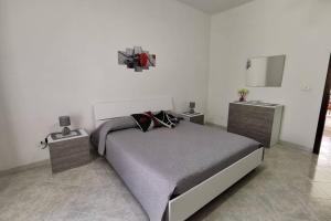 a bedroom with a large bed and two night stands at Casa vacanze Manuel, da Maruzzella in Procida