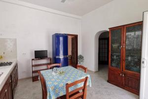 a kitchen with a table and a blue refrigerator at Casa vacanze Manuel, da Maruzzella in Procida