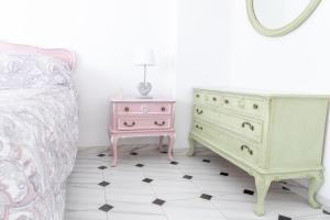 a bedroom with a bed and a dresser and a mirror at Ama in Estepona