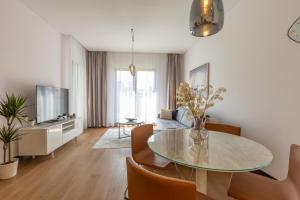 a living room with a table and a couch at Belgrade Center Apartment Lux in Belgrade