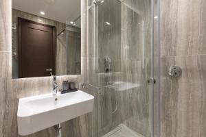 a bathroom with a sink and a shower with a mirror at Belgrade Center Apartment Lux in Belgrade +57 photos