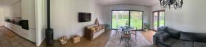 a living room with a couch and a chandelier at Kulautuva Rest Home in Kulautuva