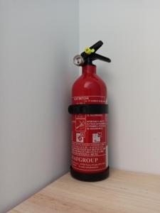 a fire extinguisher is sitting on a table at Surf & Kite - Villa Nortada in Charneca