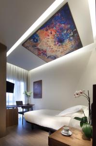 a bedroom with a large painting on the ceiling at Hotel Abades Recogidas in Granada