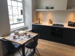 a kitchen with a table and chairs with wine glasses at Hartje Goes! in Goes