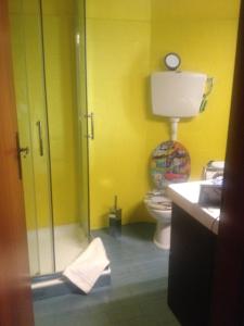 a bathroom with a toilet and a glass shower stall at Residenza Il Porto in Padenghe sul Garda +20 photos