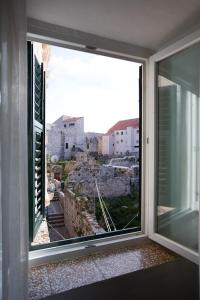 a window with a view of the city at Room Mirella in Dubrovnik