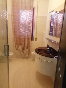 a bathroom with a sink and a shower at Feriepuntograzia in Porto Potenza Picena