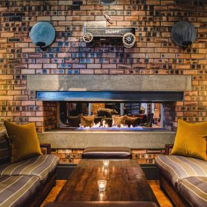 a living room with a fireplace with a car on the wall at Dakota Eurocentral in Motherwell