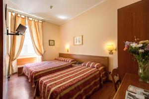 Postel nebo postele na pokoji v ubytování Buonarroti Home