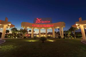 a sign for an entrance to a masquerade at Xperience Kiroseiz Parkland in Sharm El Sheikh
