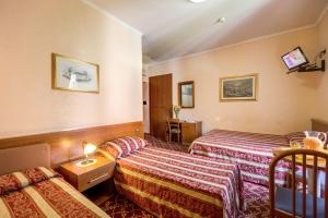 מיטה או מיטות בחדר ב-Buonarroti Home