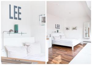 een witte slaapkamer met witte meubels en een witte bank bij fewo1846 - Strandresidenz Wassersleben Lee - strandnahes Studioapartment im Dachgeschoss in Harrislee