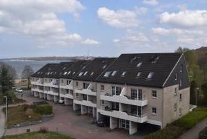 an aerial view of a building with solar panels on it at fewo1846 - Strandresidenz Wassersleben AHOI - strandnahes Studioapartment im Dachgeschoss in Harrislee