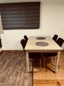 a table and chairs in a room with a window at אירוח חם בלב in Qiryat Shemona +5 photos