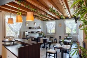 a restaurant with tables and chairs and windows at Hotel Rovere in Treviso
