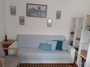 a living room with a white couch and a chair at monte da boa fé in Estremoz