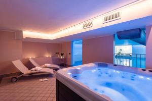 a large bath tub in a room with a balcony at Residenza Santa Cecilia in San Vincenzo