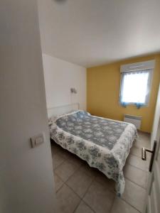 a bedroom with a bed and a window at T3 au bord de mer in Saint-Cyr-sur-Mer