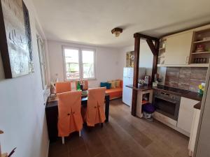 a kitchen with a table and chairs and a dining room at San na vodi in Smederevo