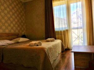 A bed or beds in a room at Kazbegi Inn