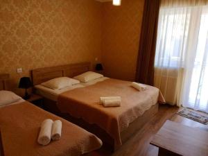 A bed or beds in a room at Kazbegi Inn