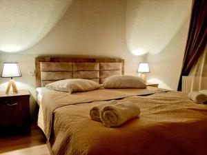 a bedroom with a large bed with towels on it at Kazbegi Inn in Stepantsminda