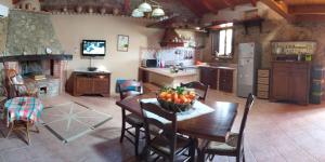 a kitchen with a table with a bowl of fruit on it at Casale Chiara & Giulia in Santa Caterina Dello Ionio Marina