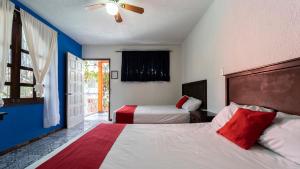 Voodi või voodid majutusasutuse Hotel Posada Bugambilias toas