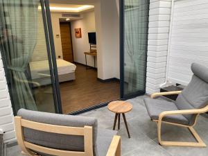 a balcony with two chairs and a table and a bed at MİYAS LUXURY HOTEL in Kemer