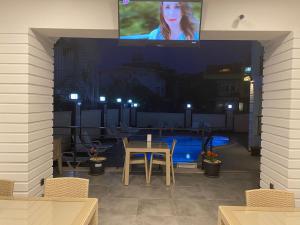 a view of a patio with a table and a tv at MİYAS LUXURY HOTEL in Kemer