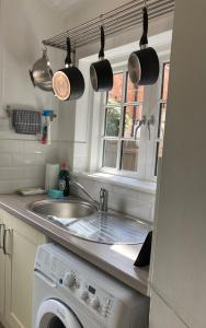 a kitchen with a sink and a washing machine at 5 Union Road in Lincoln